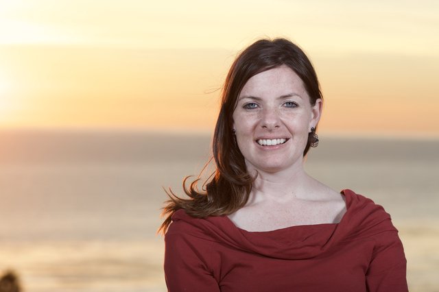 Radiant Woman Smiling at Golden Hour Beach