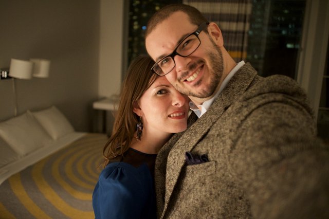 Romantic Couple Selfie in Warmly Lit Hotel Room