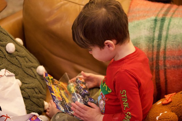 Child Opening Action Figure on Christmas Morning