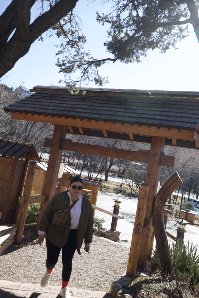 Visitor at Traditional Japanese-Style Garden Gate