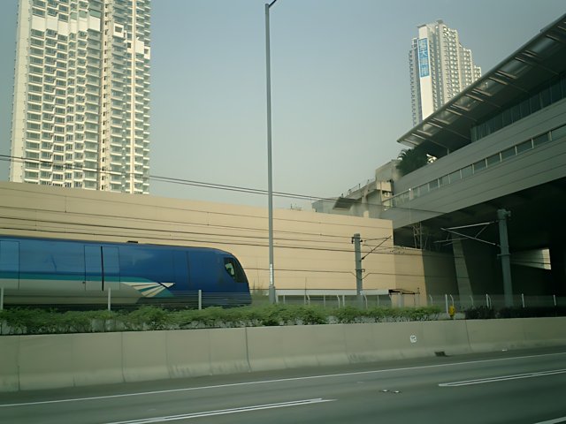 Train passing next to Urban Skyscraper