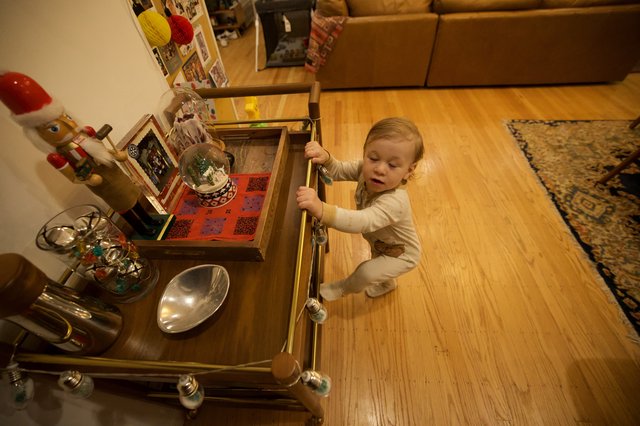 Toddler Exploring Holiday Decorations in Living Room Drawer