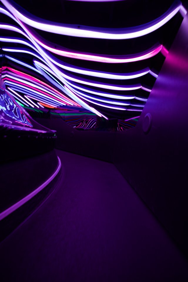 Neon Tunnel with Curved Light Strips and Purple Glow