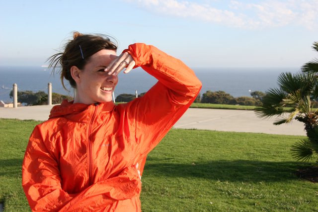 Windswept Woman Shielding Eyes by the Sea