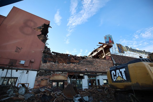 Demolished Building Under Clear Blue Sky with CAT Excavator