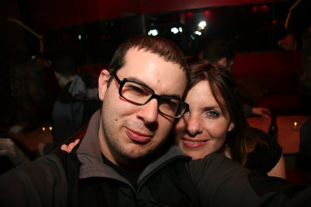 Couple Smiling Together at Dimly Lit Nightclub
