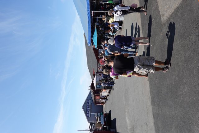 Busy Waterfront Market Scene with Crowds