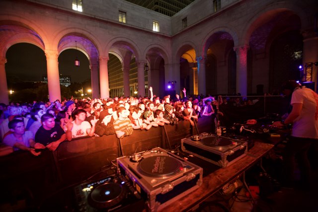 DJ Georgie Farmer performing for a crowded urban club
