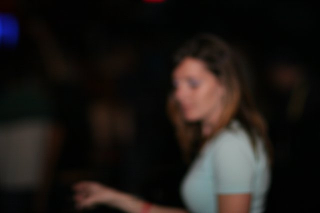 Woman Looking Back in Dark Nightclub Setting
