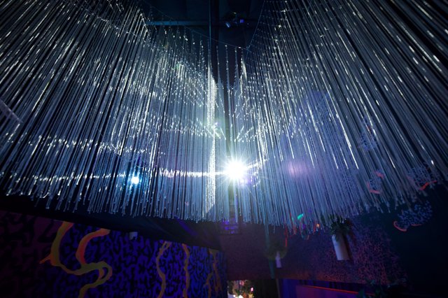 Illuminated Crystal Chandelier Installation in Museum Space