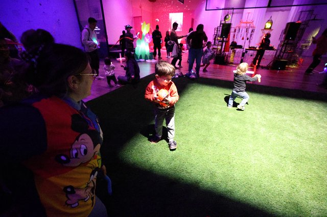 Children Dancing Under Colorful Lights at Baby Rave Event