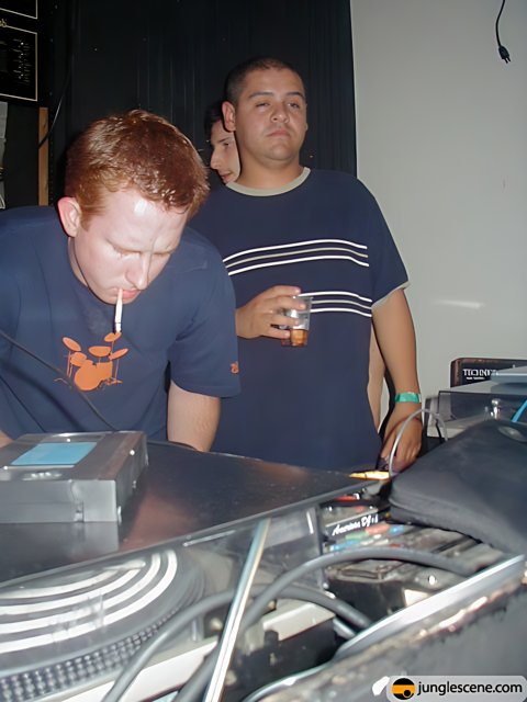 Mastering the Music: Two Men at the DJ Mixer