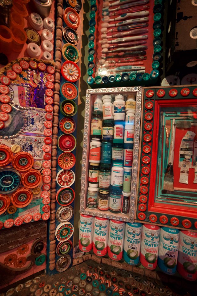 Vibrant Medicine Cabinet Shrine in Eclectic Bottle Cap Art Installation