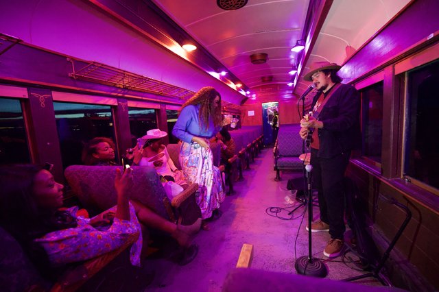 Intimate Live Music Performance on Purple-Lit Train Car