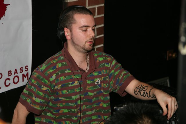 Tattooed DJ Mixing Up a Hit