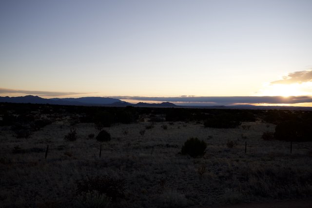 Desert Sunset Over Distant Mountain Range