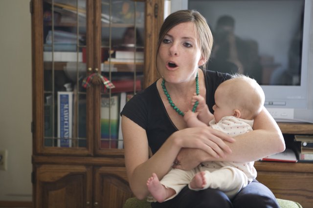Young Mother Singing to Her Infant at Home