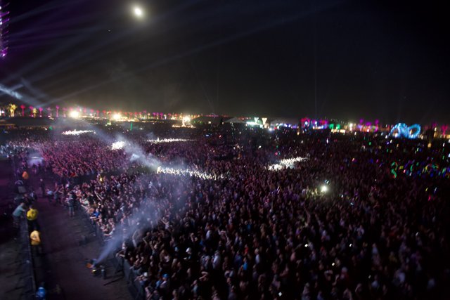 A sea of music lovers under the night sky