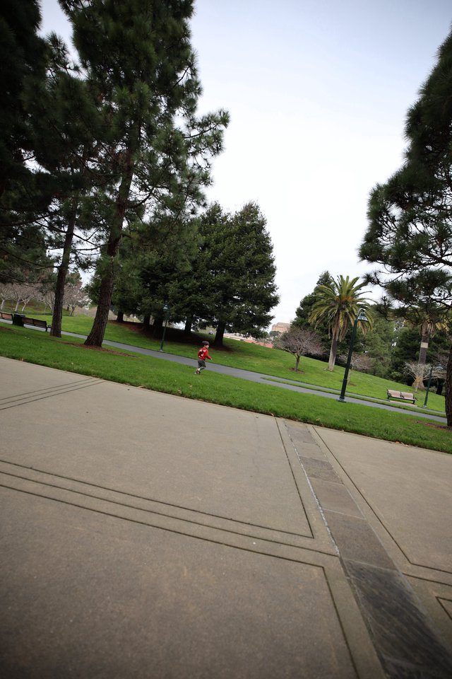 Child Running Through Park on Overcast Day