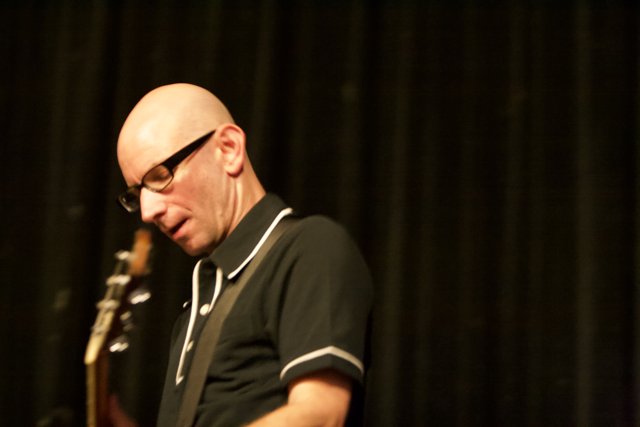 Bald man rocks out on guitar at Bad Religion concert