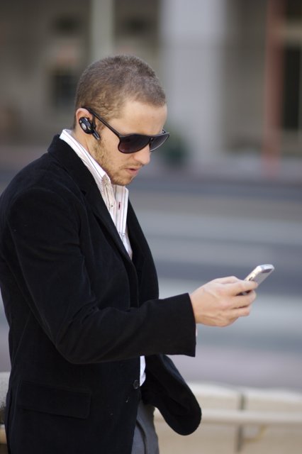 Black Jacket, Sunglasses and Mobile Phone