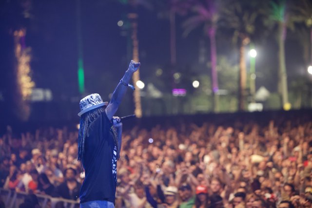 Triumphant Man with Dreadlocks Lights Up Coachella Stage