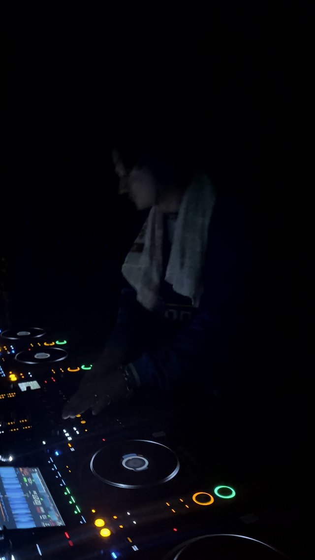 DJ Behind the Decks at Night Club Performance