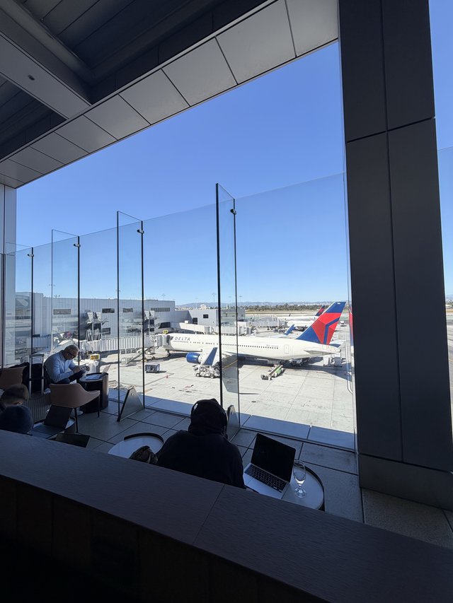 Airport Lounge Workspace with Delta Aircraft on Tarmac