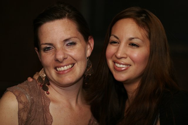 Two Women Smiling at a Night Event