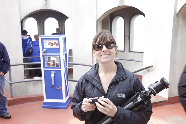 Photographer Smiling at Pressed Penny Souvenir Machine