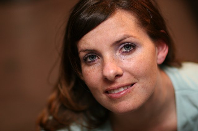 Freckled Woman with Blue Eyes Smiling Warmly