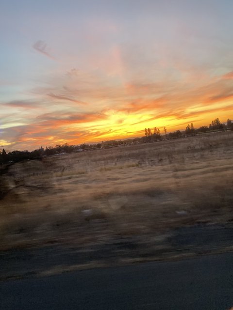A Breathtaking Sunset View from a Car Window