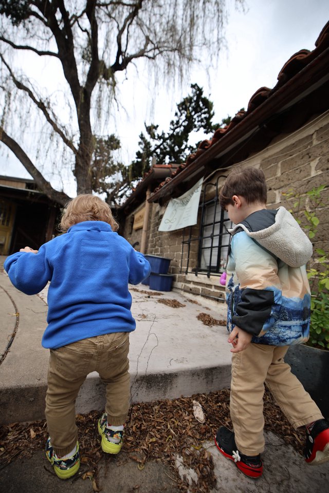 Two Young Boys Exploring a Historic Adobe Courtyard