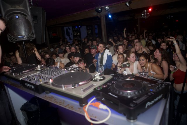 DJ Entertaining the Urban Crowd at Nightclub