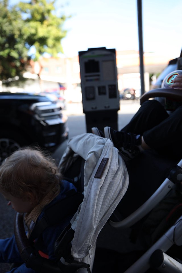 Child in Stroller on Sunny Street