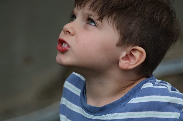 Young Child Looking Upward with Playful Expression