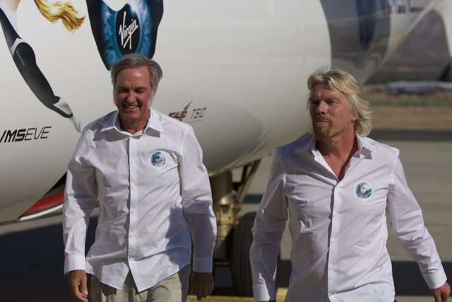Richard Branson and Burt Rutan Walking Next to Their Aircraft
