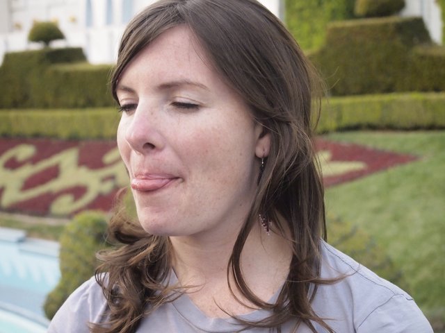 Woman Making a Playful Face in Formal Garden