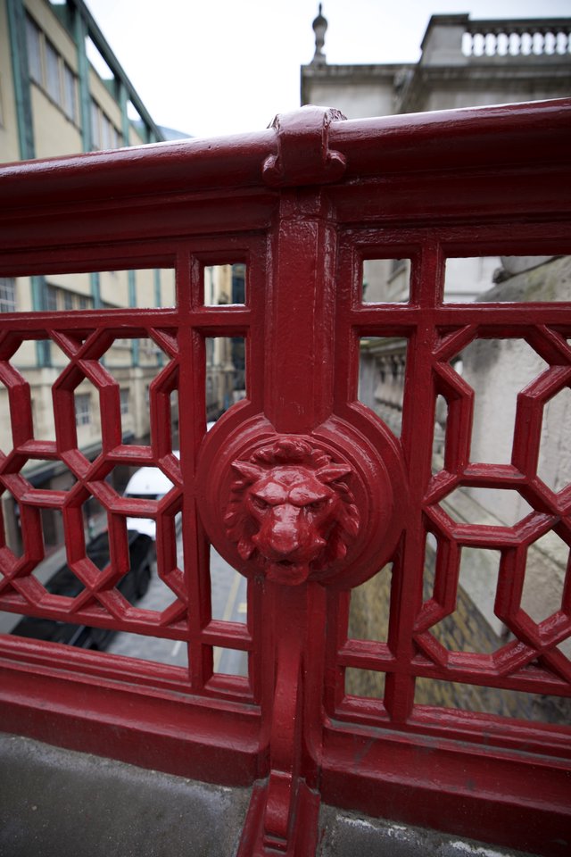 Ornate Lion Head Detail on Victorian Red Bridge Railing