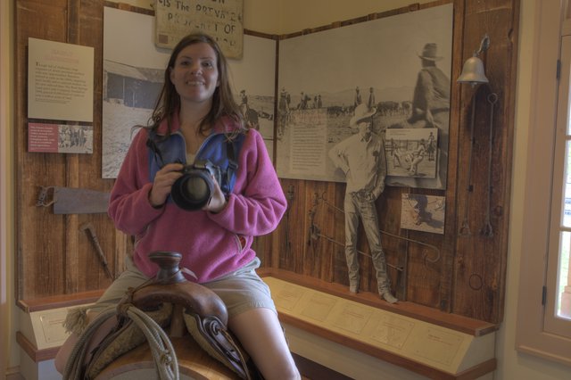 Tourist Poses on Saddle at Western Ranch Museum