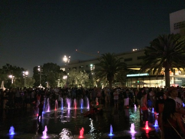 Nighttime Gathering Around the Illuminated Fountain