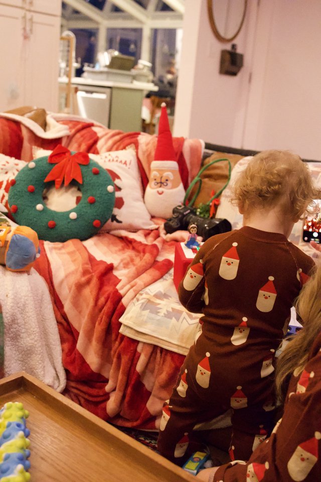 Toddler's Christmas Morning with Festive Decorations and Toys