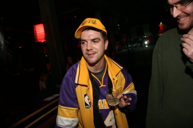 Lakers Fan enjoying a drink Caption: Lenny R shows off his Lakers gear while enjoying a drink at the pub in 2006.