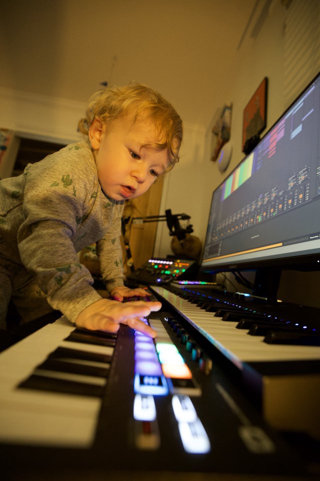Young Child Exploring Music Production at Home Studio