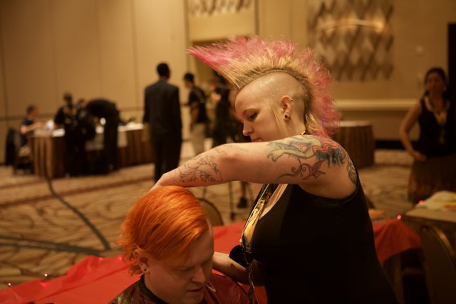 Pink-haired woman getting a tattoo