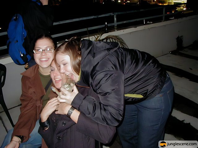 Three Women Embrace on New Year's Eve