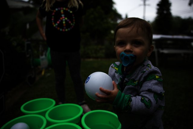 Fun at the Grad Party: A Young Boy and His Ball