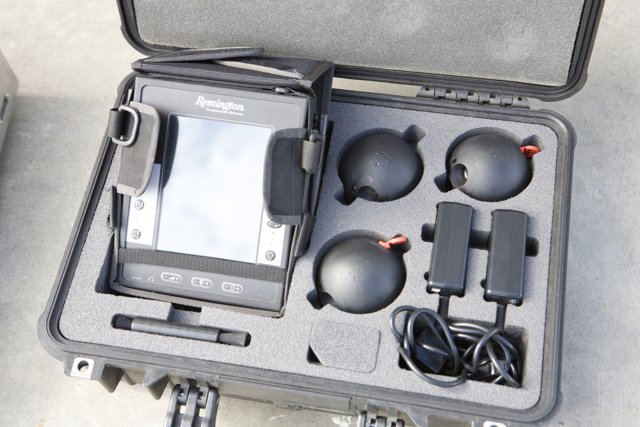 Electronics Travel Kit Caption: A case containing a tablet, headphones, and adapters for various devices, ready to take on the go.