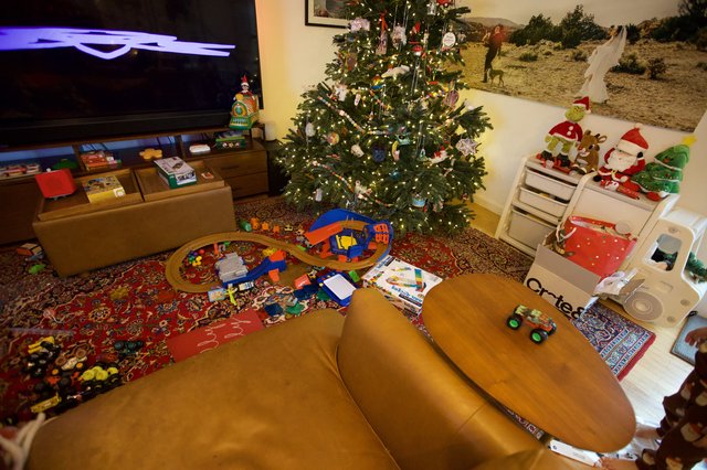 Christmas Morning Living Room with Scattered Toys and Decorations