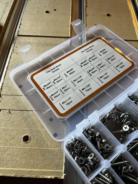 Assorted Hardware Screws and Nuts in a Plastic Box